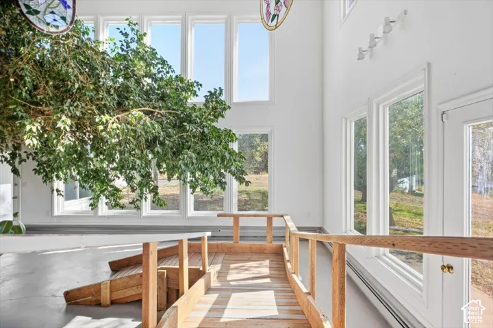 Two-story windows, vaulted ceiling, and wood-finish railing