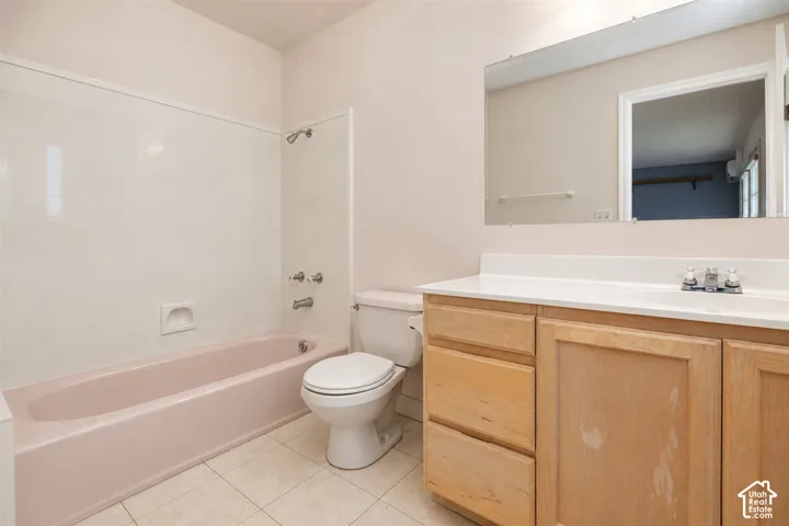 Wall-mounted mirror over a vanity with light wood-finish cabinetry, white countertop, and integrated sink