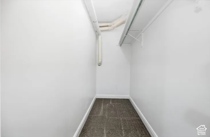 White painted walls with gray carpet flooring and white trim
