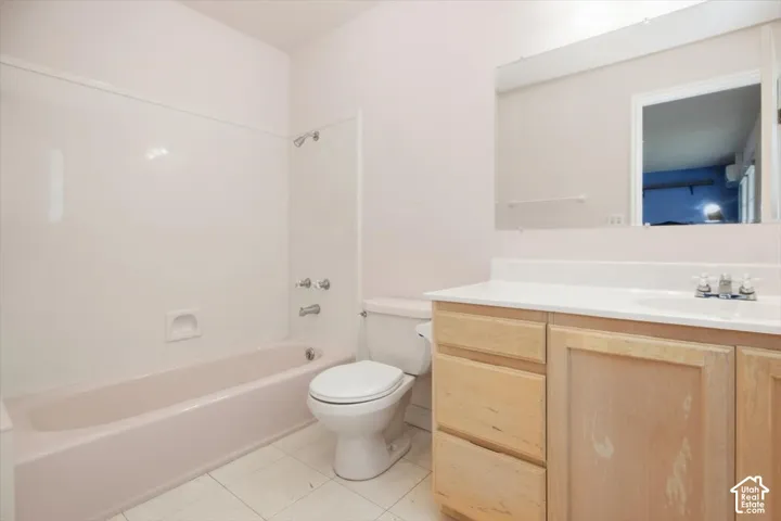 Light wood-finish vanity with white countertop and integrated sink