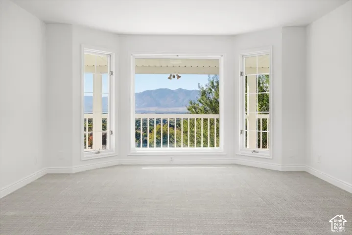 Bay window with multiple panels, white trim, light-colored walls, and carpeting