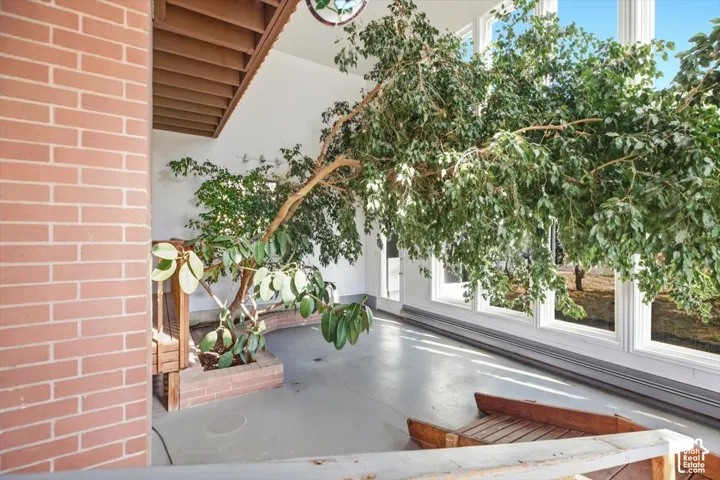 Interior brick column, built-in planter with brick surround, and floor-to-ceiling windows
