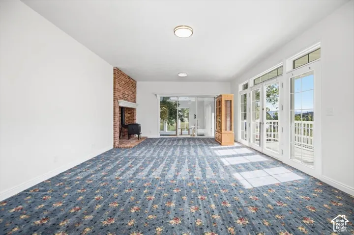Spacious room with a brick fireplace and wood-burning stove
