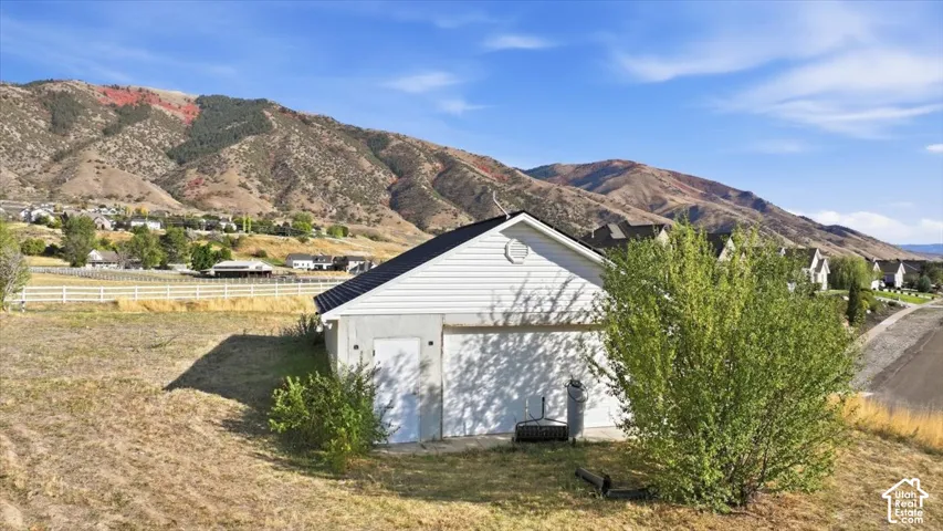 Detached garage with two garage doors and an additional entry door