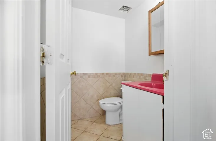 White paneled doors, white walls, and a built-in vanity with a red countertop