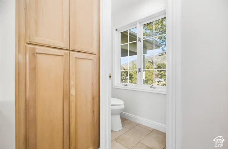 Built-in wood-finish cabinetry, tile flooring, and a multi-pane window