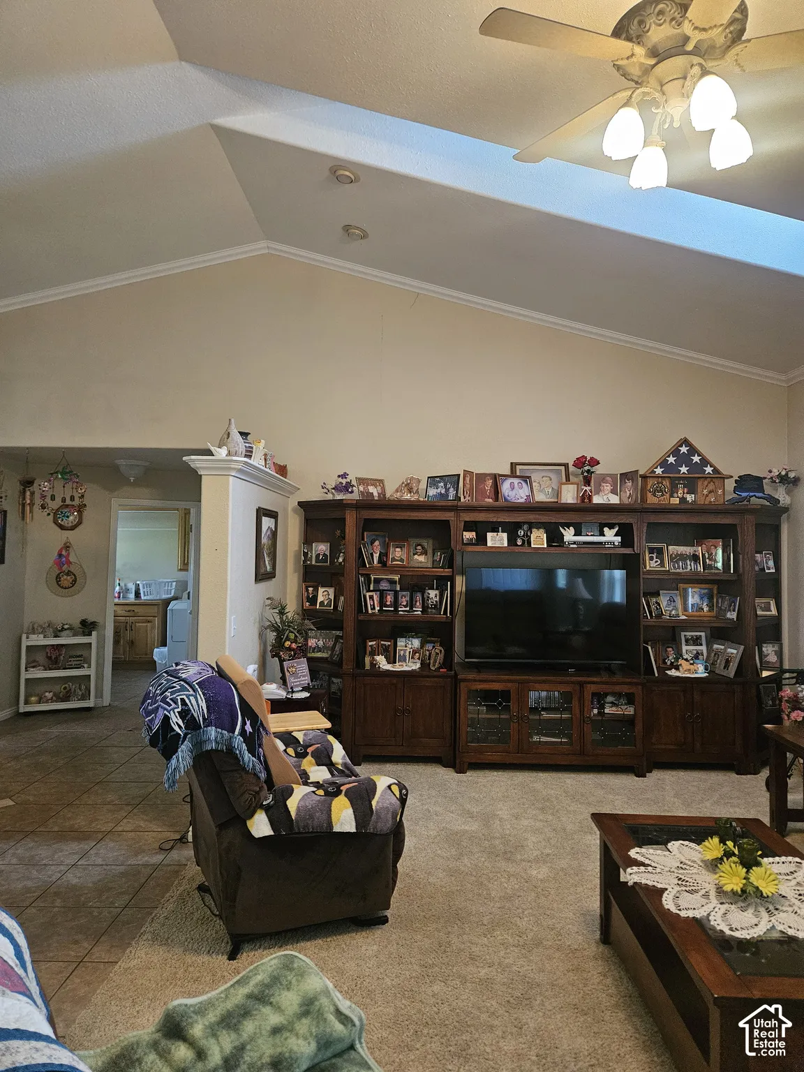 Vaulted ceiling featuring a ceiling fan with light fixture, recessed lighting, and crown molding
