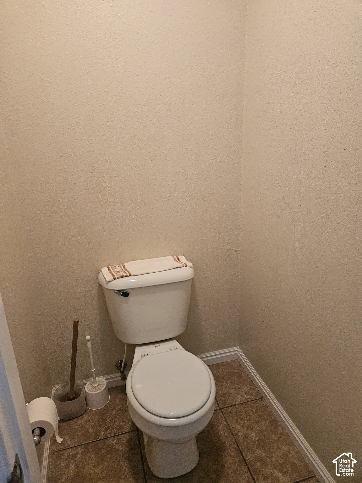 Tile flooring with a neutral wall finish and white trim