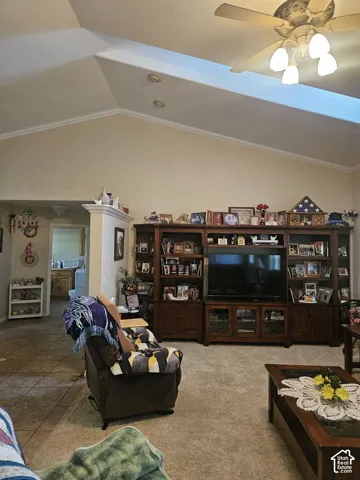 Vaulted ceiling featuring a ceiling fan with light fixture, recessed lighting, and crown molding
