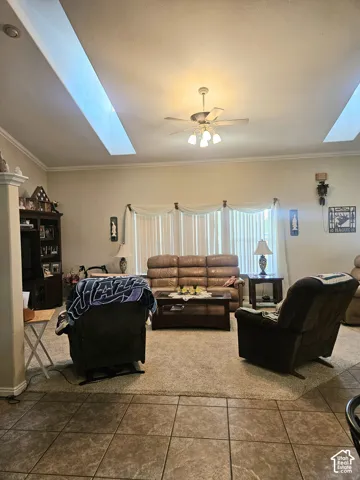 Living area featuring a ceiling fan, recessed lighting, and crown molding