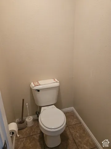 Tile flooring with a neutral wall finish and white trim