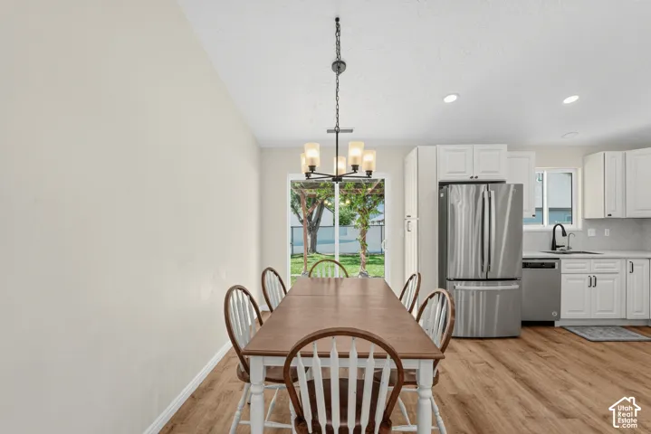 Wood-finish flooring throughout, with recessed lighting and a contemporary chandelier