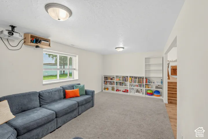 Recessed lighting, built-in shelving, and neutral wall paint