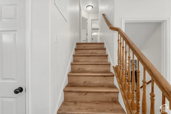 Wood-finish staircase with natural wood banister