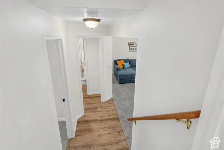 Recessed lighting, wood-finish flooring, and light-toned wall finishes