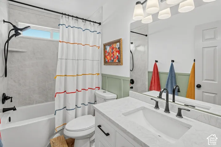 Bathroom with a white vanity featuring an integrated rectangular sink, a light-colored countertop, and matte black fixtures