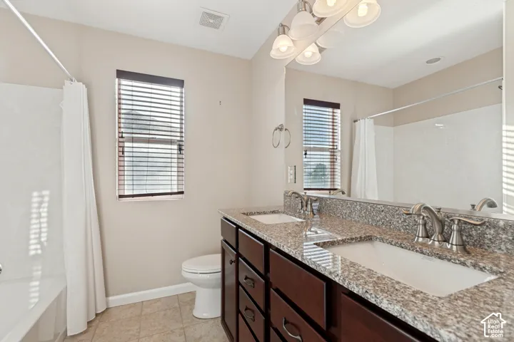 Dual vanity with undermount sinks, granite-style countertop, and brushed nickel fixtures