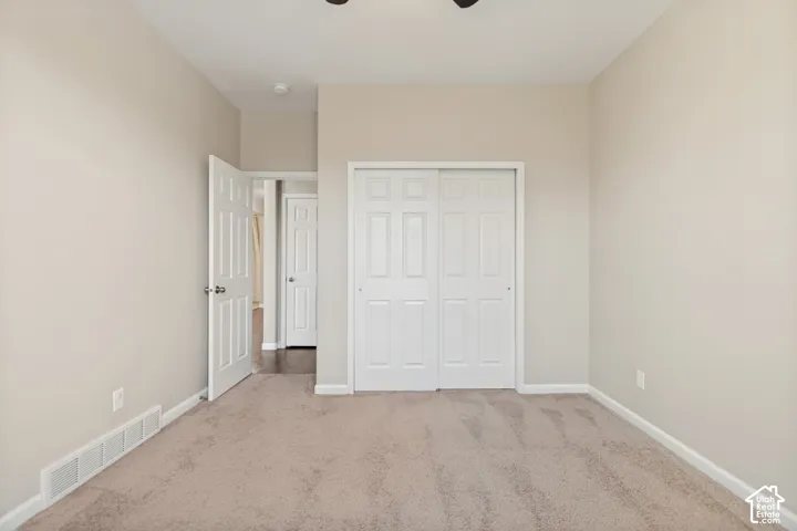 Neutral wall color, carpet flooring, interior doors, and bi-fold closet doors