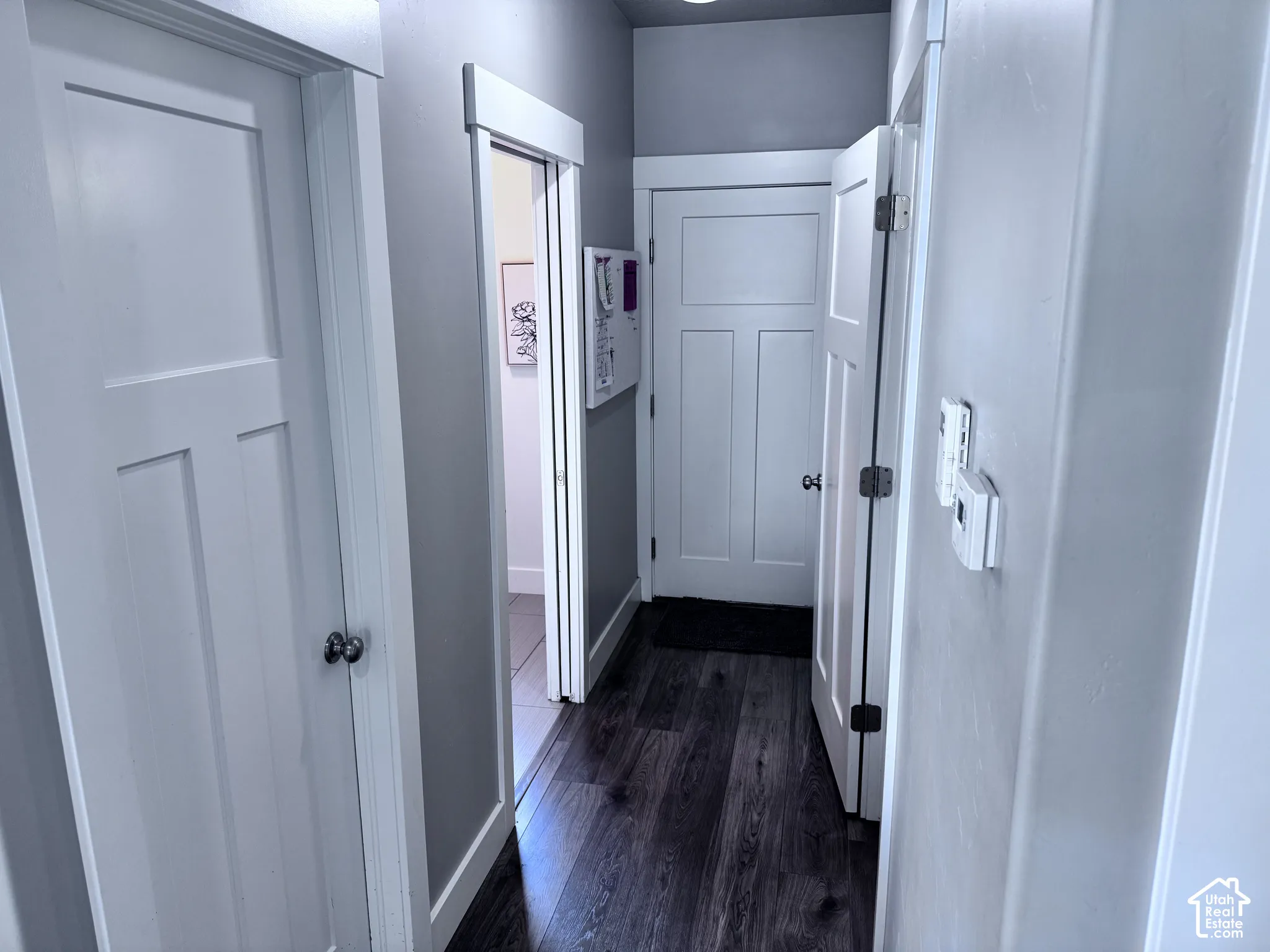 Dark wood-finish flooring with light wall paint and white trim