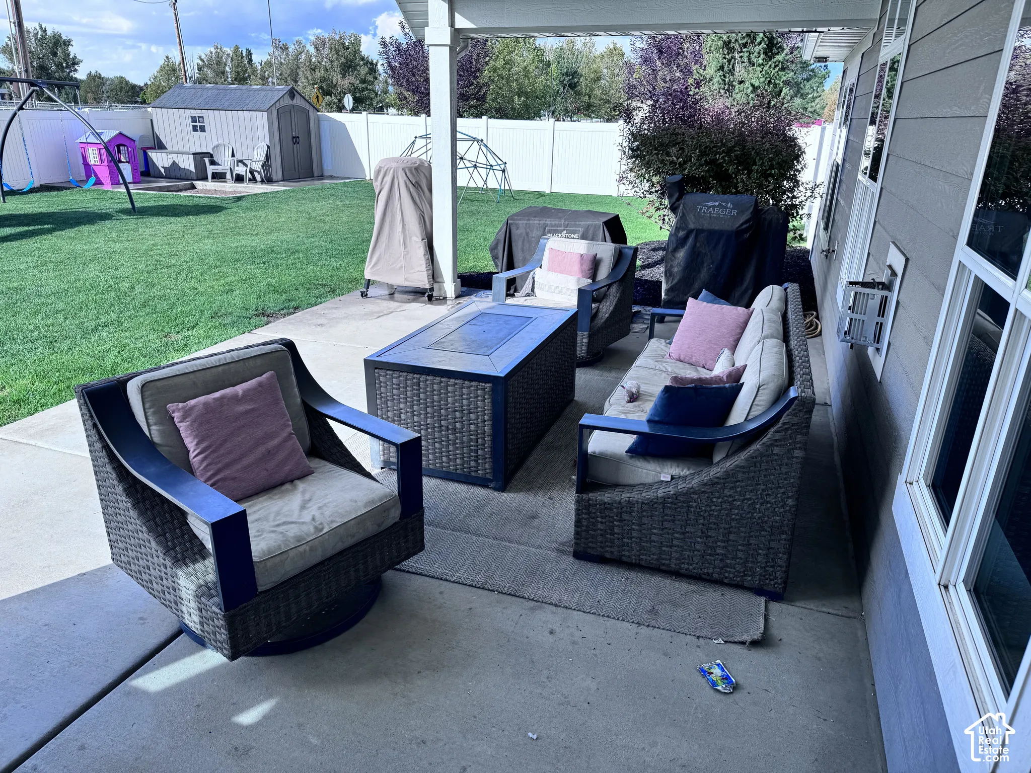 Covered patio with a concrete surface, siding exterior, and multiple windows
