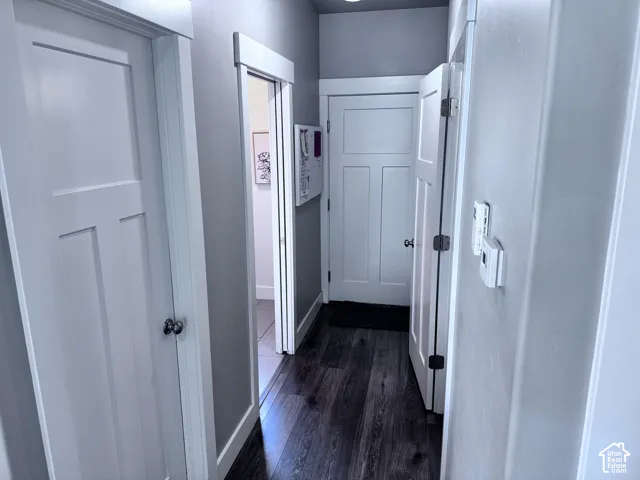 Dark wood-finish flooring with light wall paint and white trim