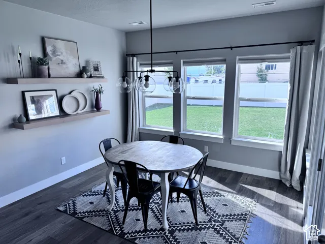 Wood-finish flooring throughout, paired with a modern linear chandelier