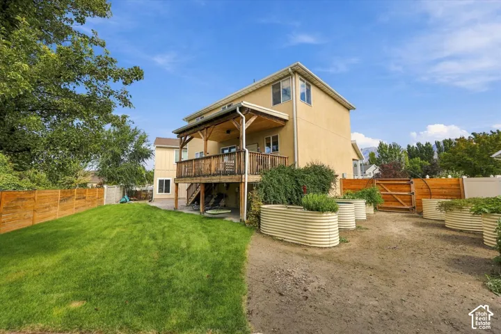 Charming farmhouse-style residence elevated on a sturdy foundation with a covered front porch and wooden railings