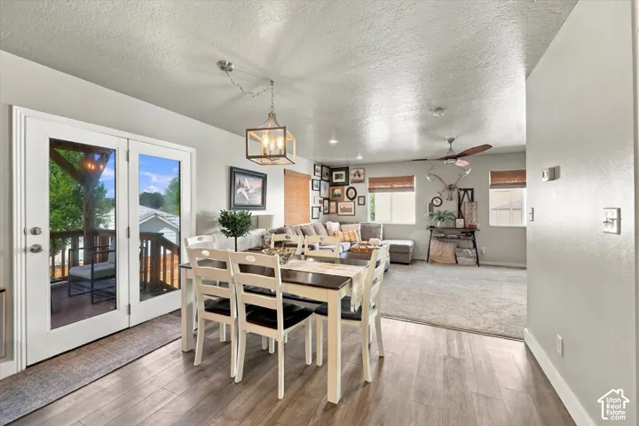 French doors opening to an exterior deck, wood-finish flooring, recessed lighting, and a ceiling fan