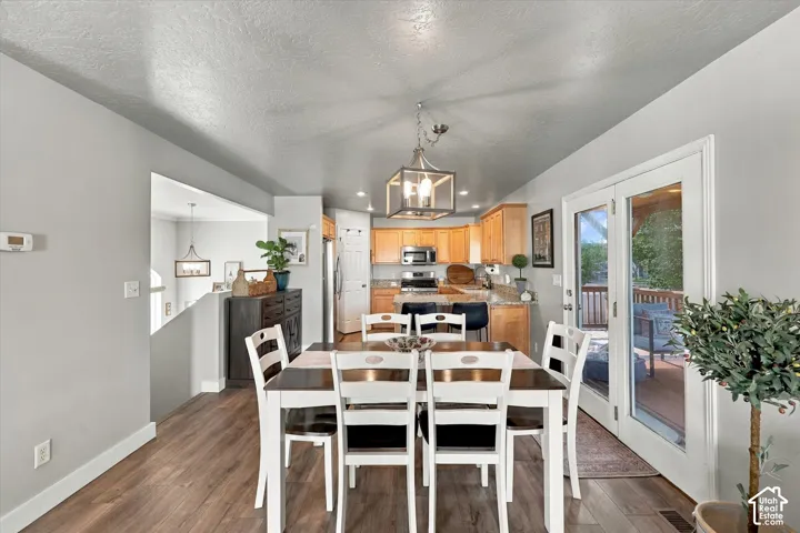 Wood-finish flooring, recessed lighting, and a white trim package