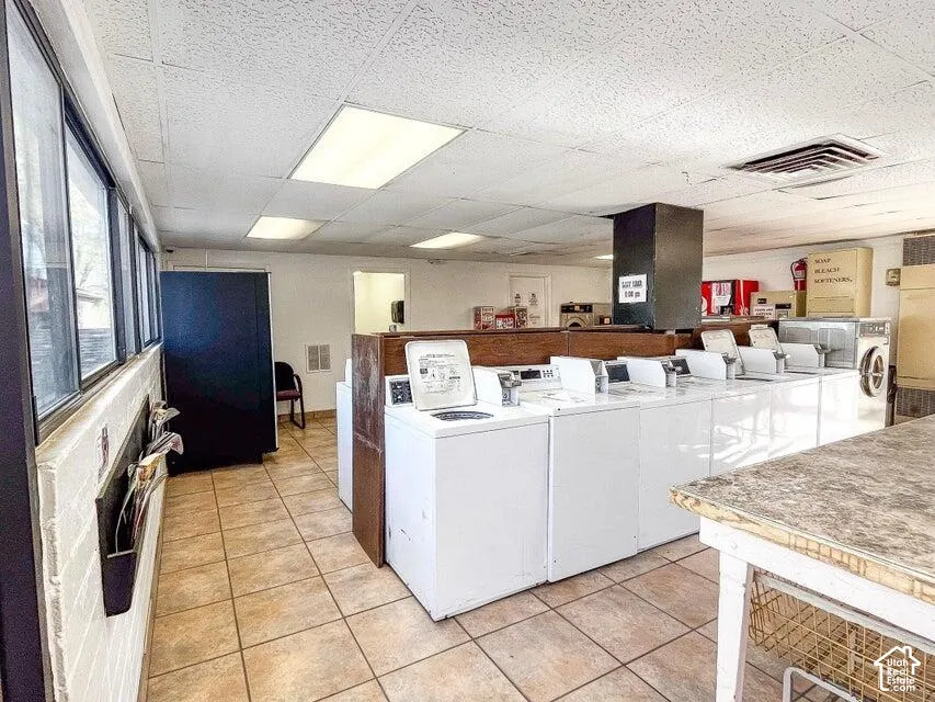 Tile flooring, expansive windows, multiple washing machines, and integrated lighting fixtures