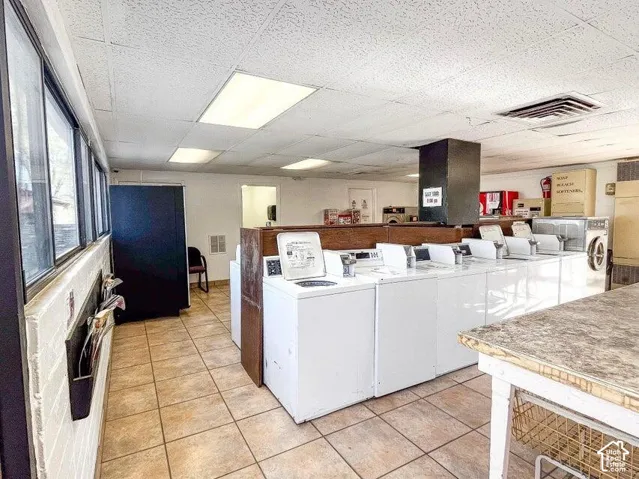 Tile flooring, expansive windows, multiple washing machines, and integrated lighting fixtures