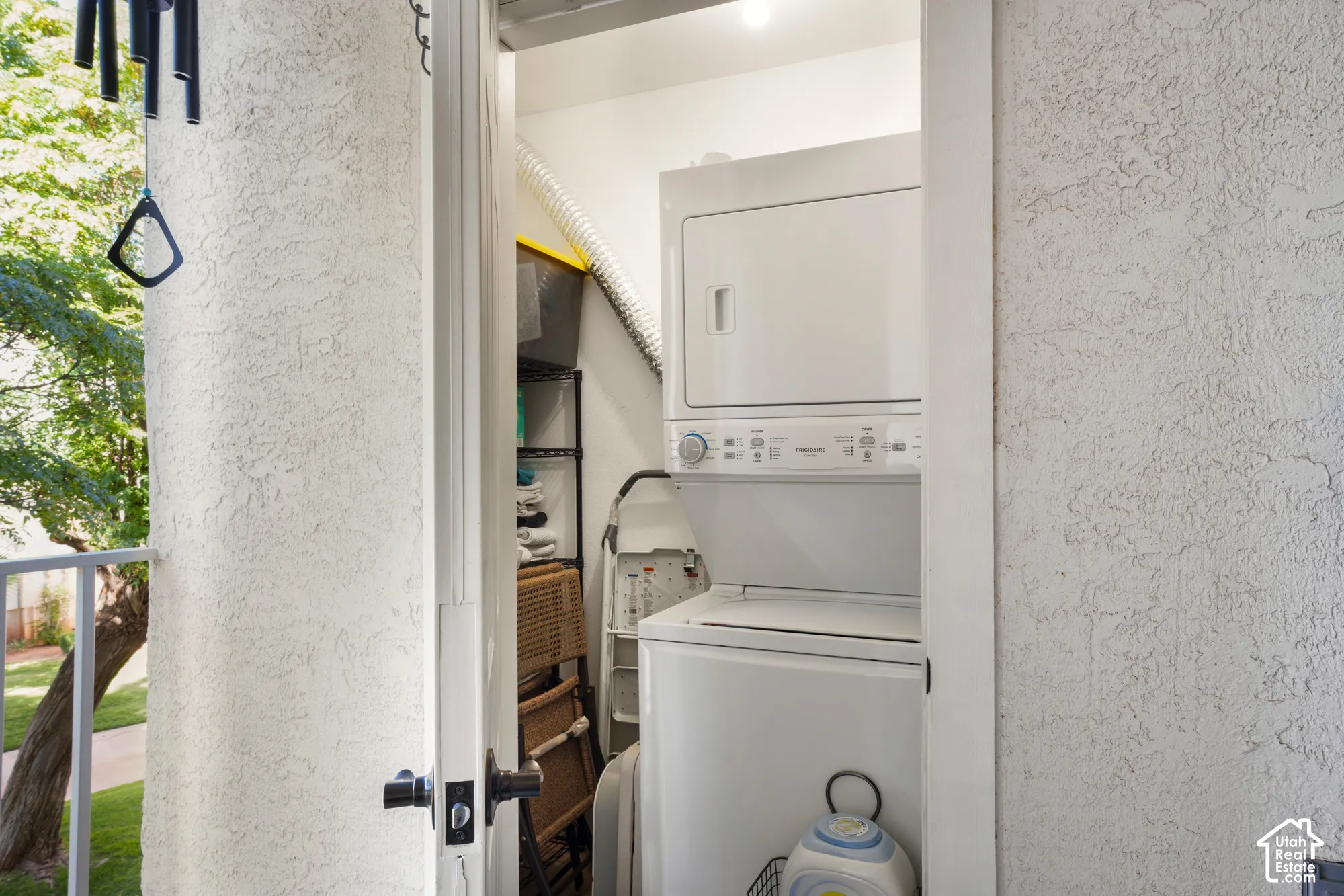Dedicated laundry area with stacked washer and dryer