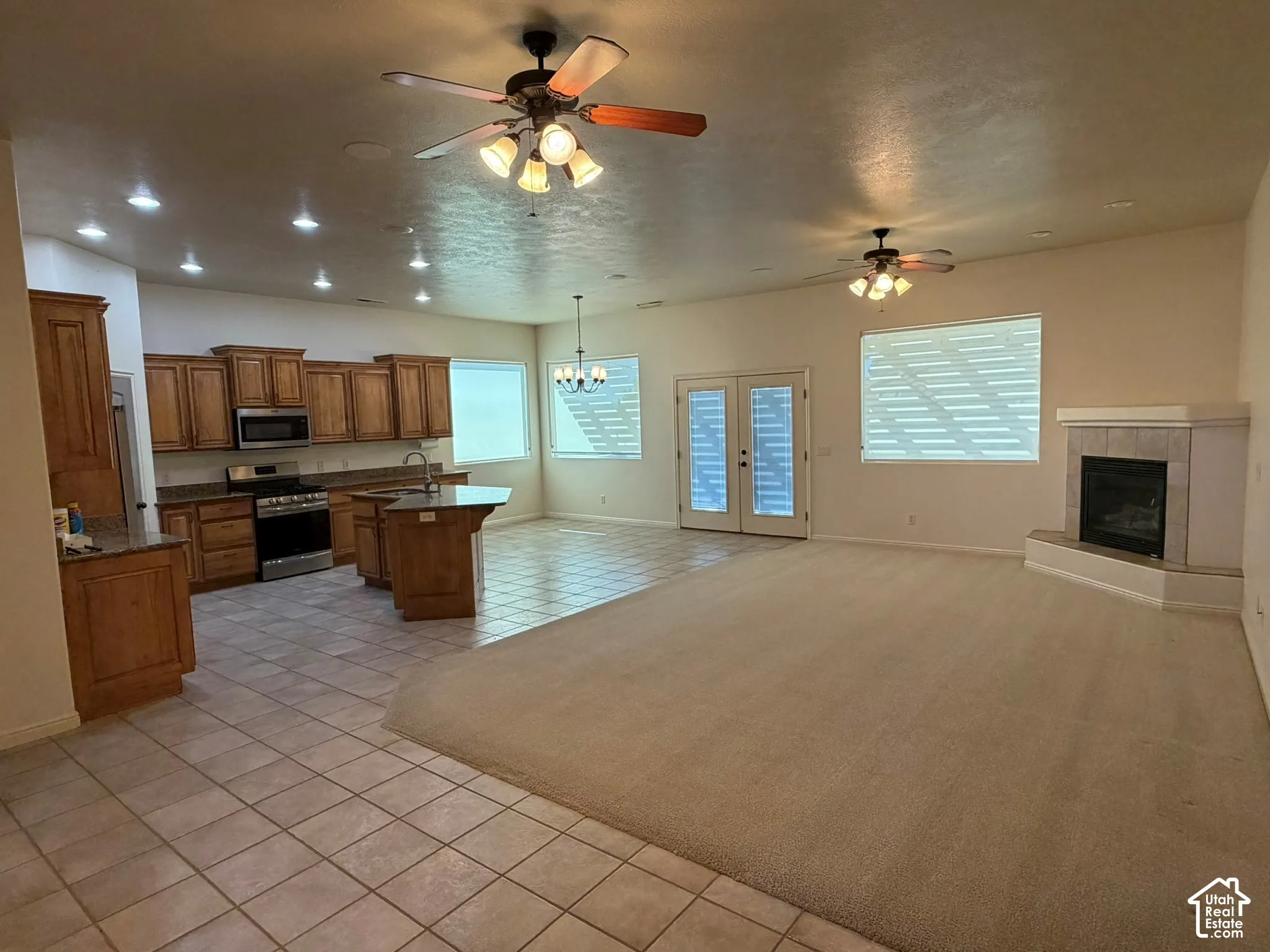 Kitchen with wood cabinetry, stainless steel appliances, and a central island