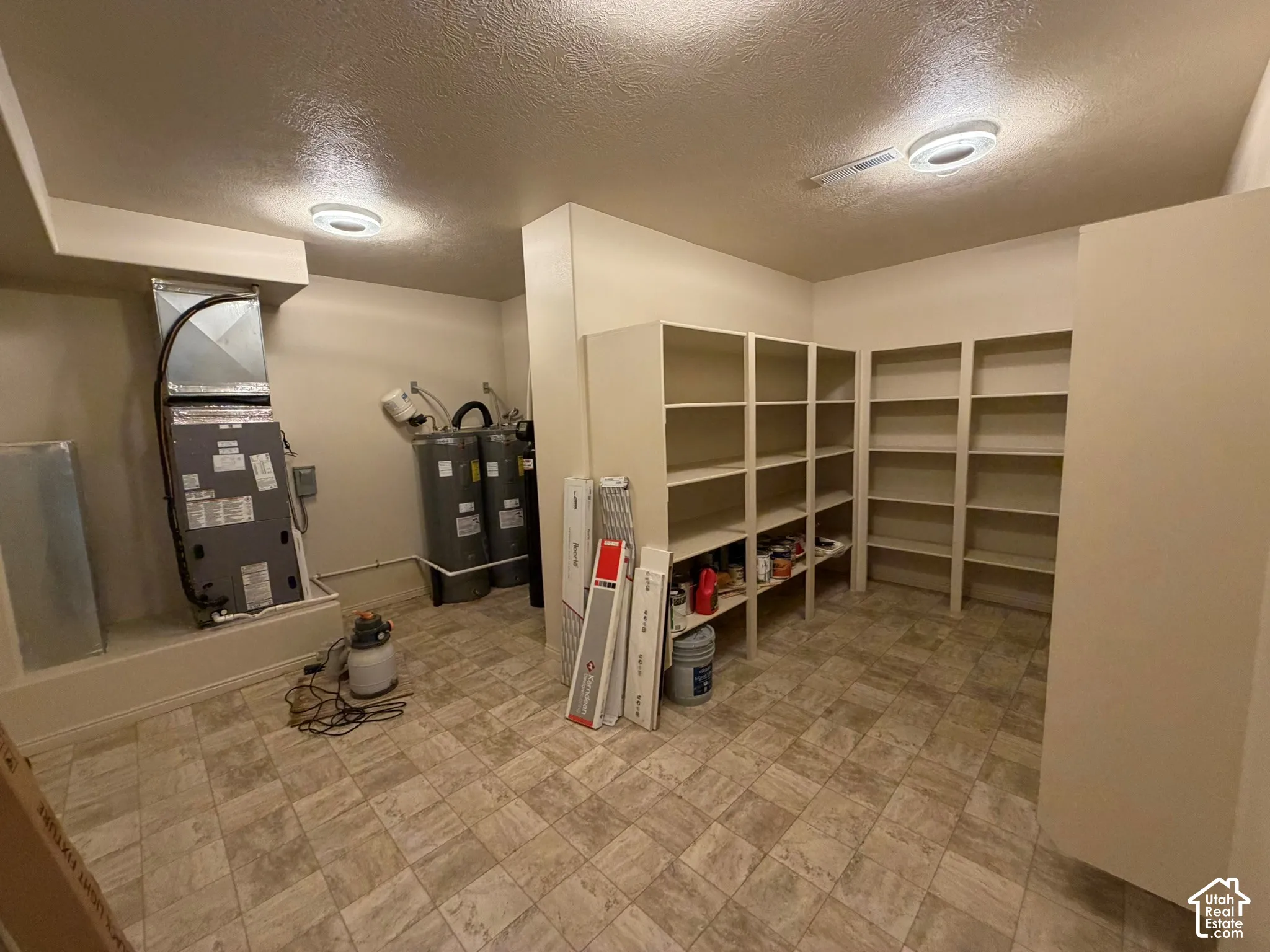 Built-in shelving, tile flooring, and ceiling-mounted light fixtures