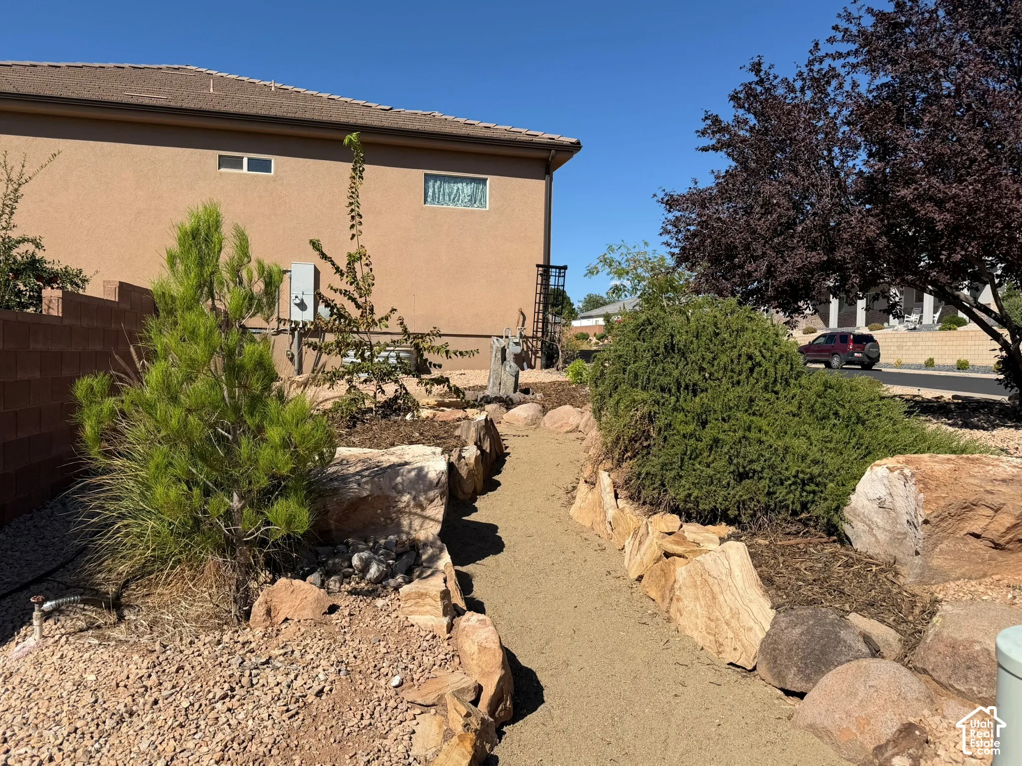 Xeriscape landscaping with a crushed gravel pathway and natural rock accents