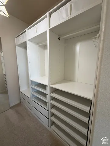 Built-in closet system featuring multiple shelves, drawers, and hanging rods for extensive organization