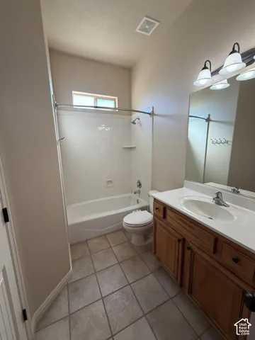 Full bathroom featuring a single vanity with wood-finish cabinetry, a drop-in sink, and a white countertop