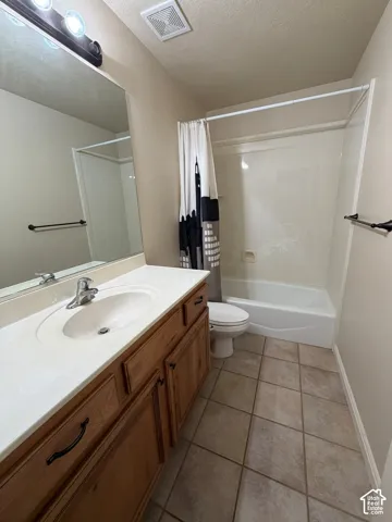 Vanity with an integrated sink, wood-finish cabinetry, and brushed nickel hardware