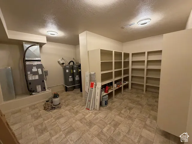 Built-in shelving, tile flooring, and ceiling-mounted light fixtures