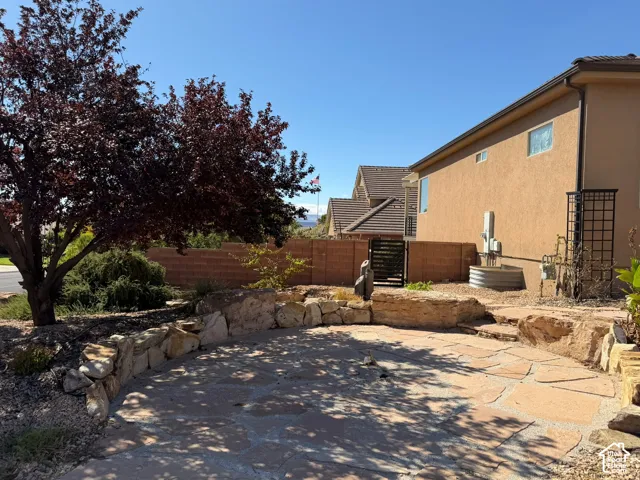Outdoor patio featuring flagstone paving and natural stone retaining walls