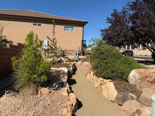 Xeriscape landscaping with a crushed gravel pathway and natural rock accents