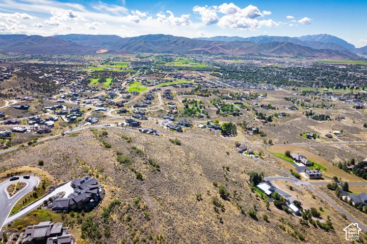 Expansive residential area featuring distant mountain ranges and scattered homes with varied architectural styles