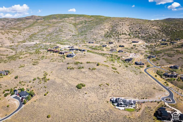 Expansive mountain landscape featuring paved roads and residential properties