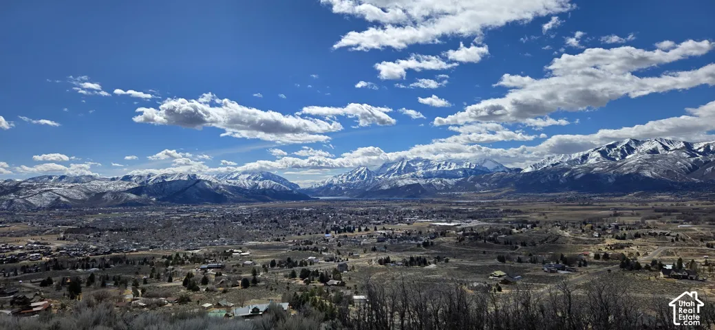 Expansive regional scenery featuring a distant mountain range and a broad valley