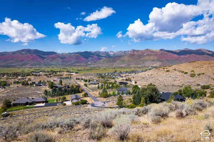 Mountainous landscape featuring expansive natural terrain and scattered residential properties