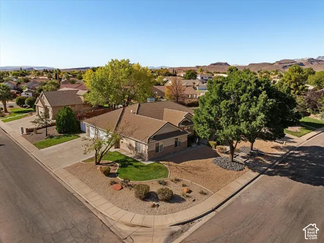 Single-story residence with a tiled roof, stone and stucco exterior, and a two-car garage