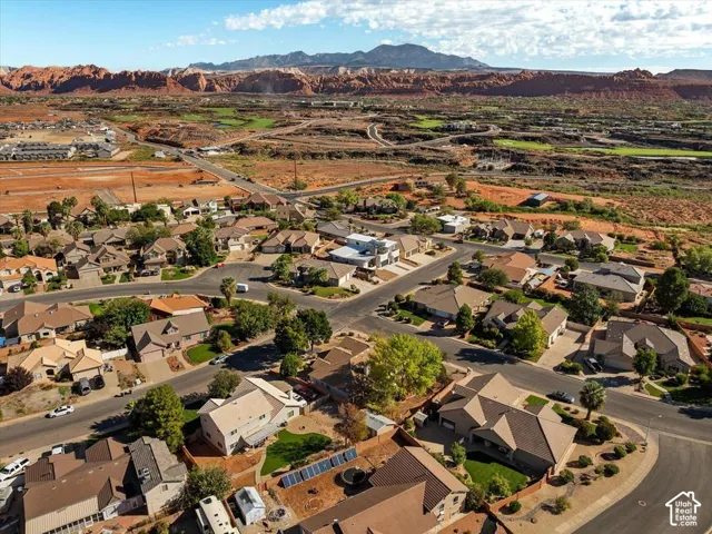 Residential neighborhood featuring various architectural styles, mature trees, and street parking