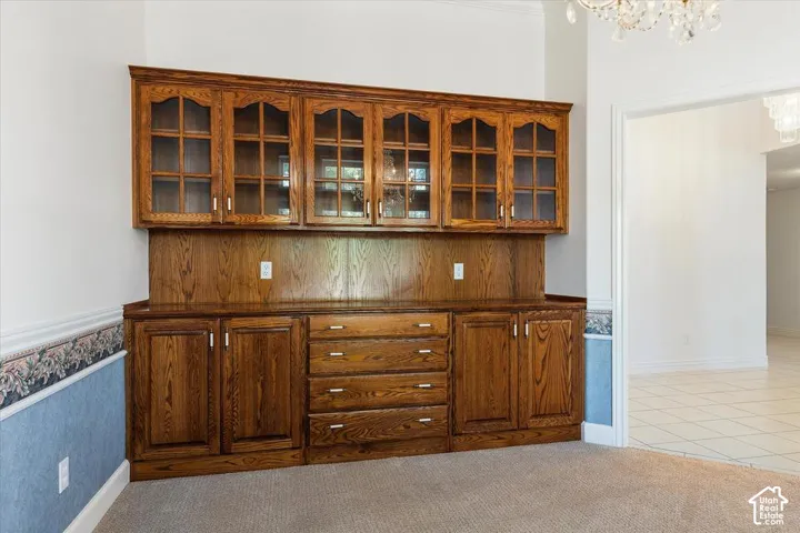 Custom built-in cabinetry with glass-front upper cabinets and solid lower doors, featuring multiple storage drawers