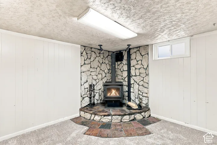 Stone-accented corner fireplace with a wood-burning stove, creating a distinct focal point
