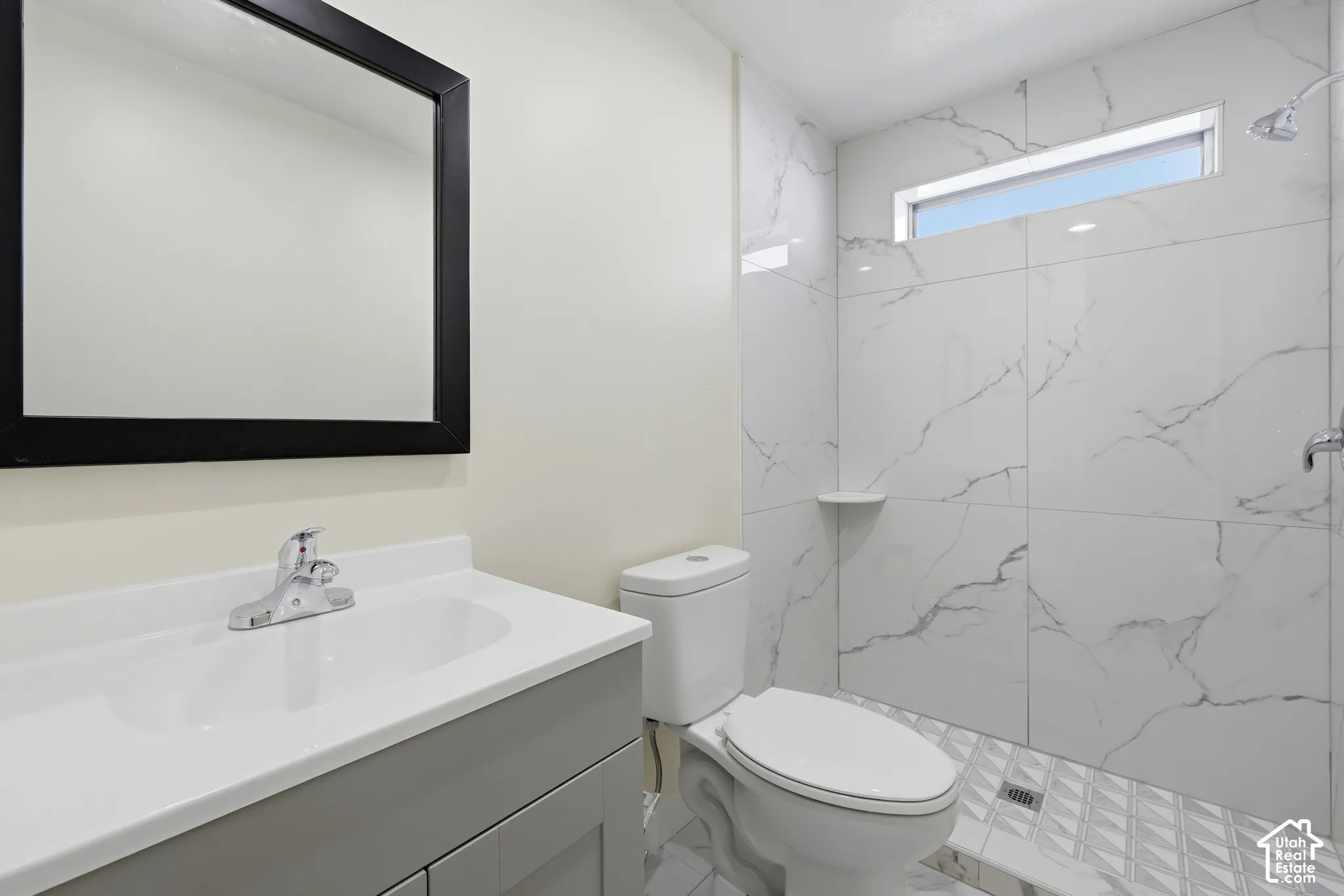 Vanity with an integrated sink and chrome faucet